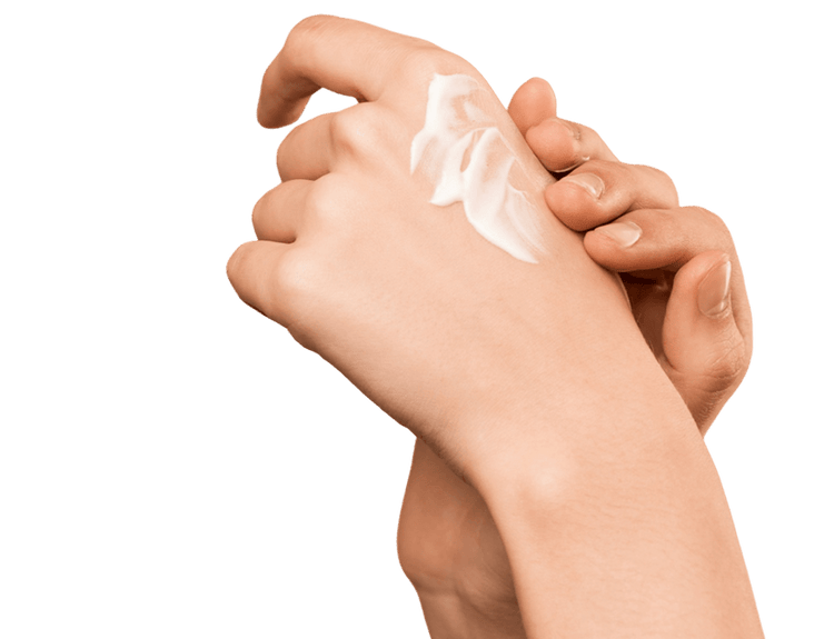 Closeup of one hand applying lotion to the other